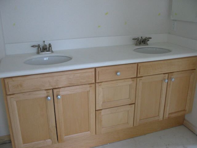 a bathroom countertop with two sinks