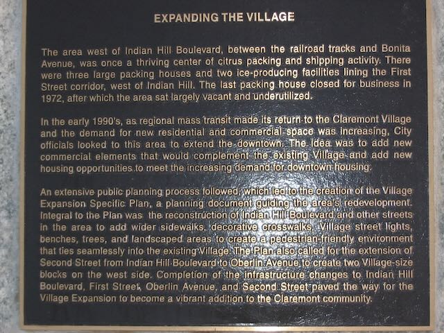 a closeup of a plaque entitled 'Expanding the Village'