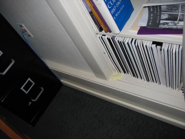 An ethernet cable emerging from the wall and disappearing into a mouling