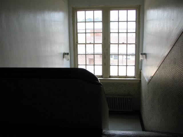 an unlit high school stairwell