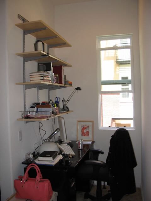 photo of my desk space with wall-mounted shelves