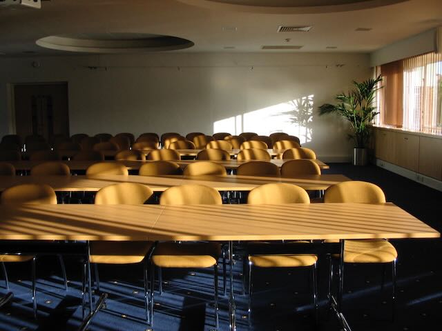 A sunlit classroom with empty seats
