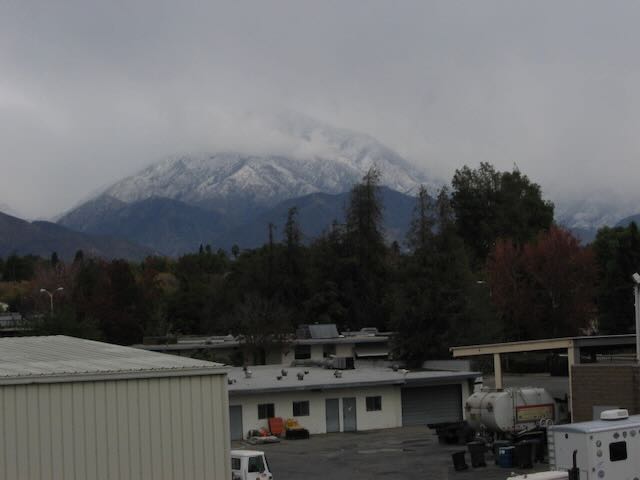 a snowcapped mountain surrounded by clouds