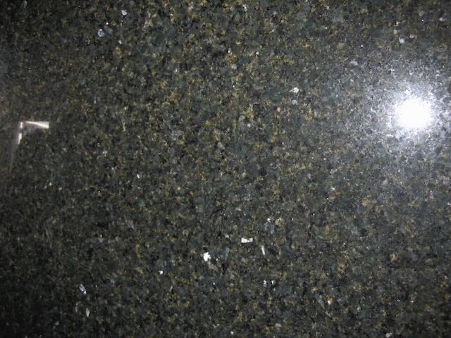 a closeup of green and black granite